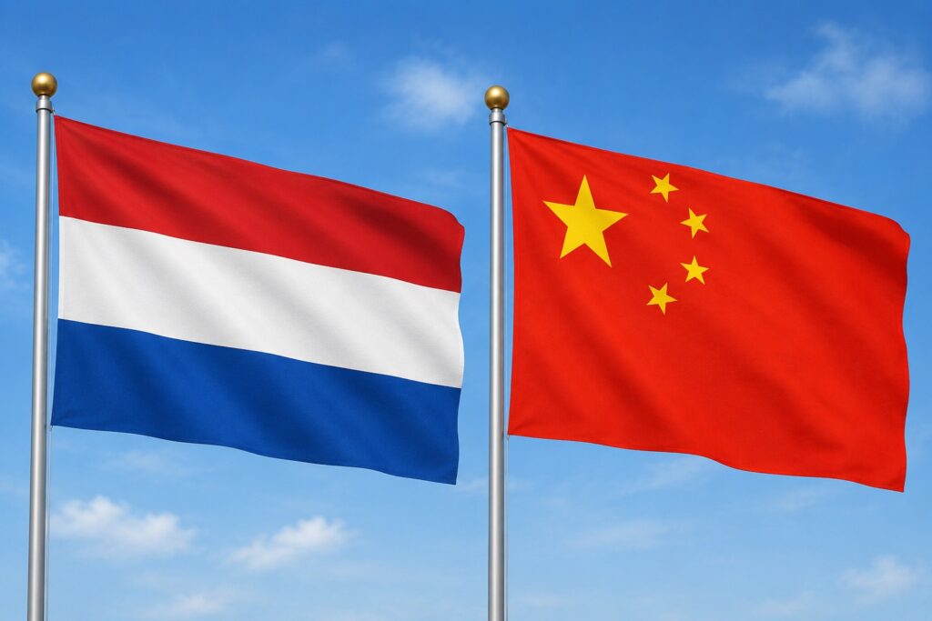 Two national flags flutter side by side: the Netherlands (red-white-blue) and China (red with yellow stars) against a blue sky.